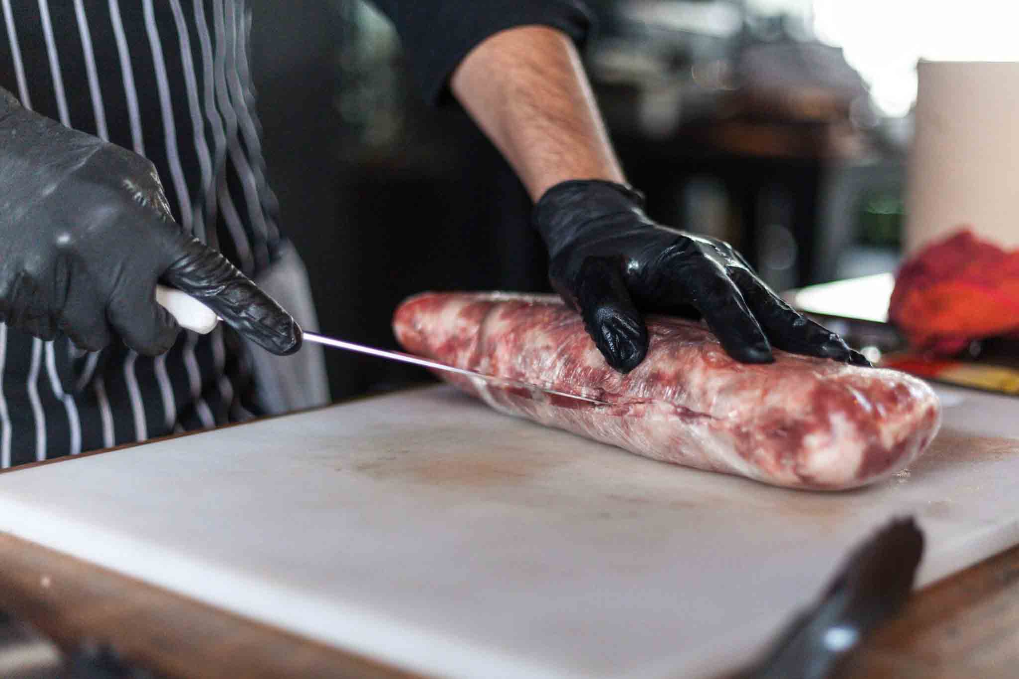 butcher cutting pork
