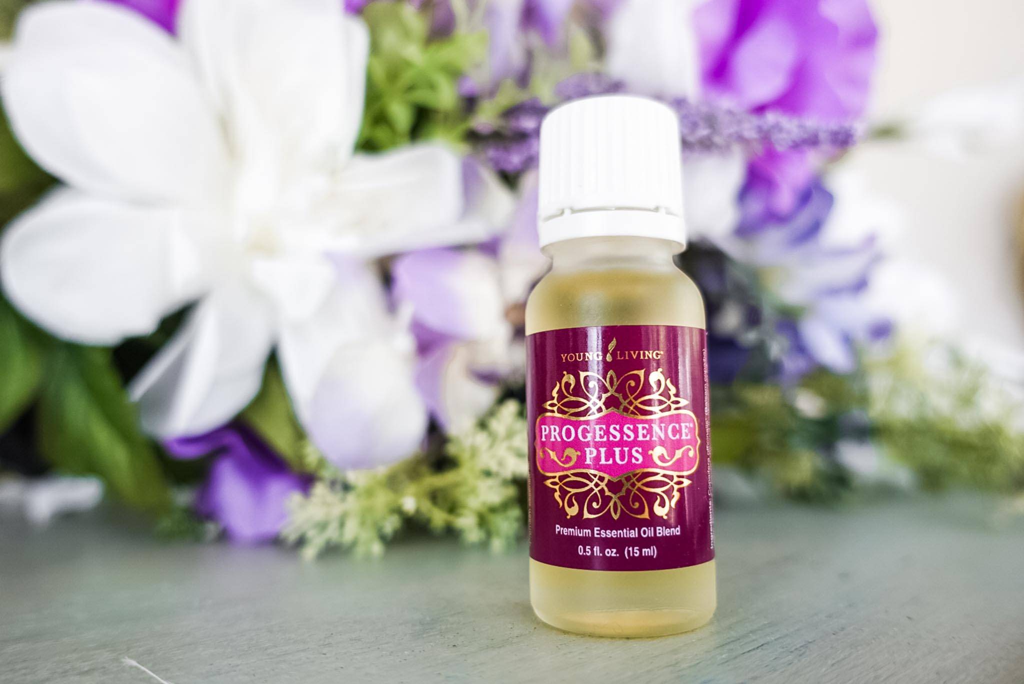 Progessence Plus in front of purple flowers