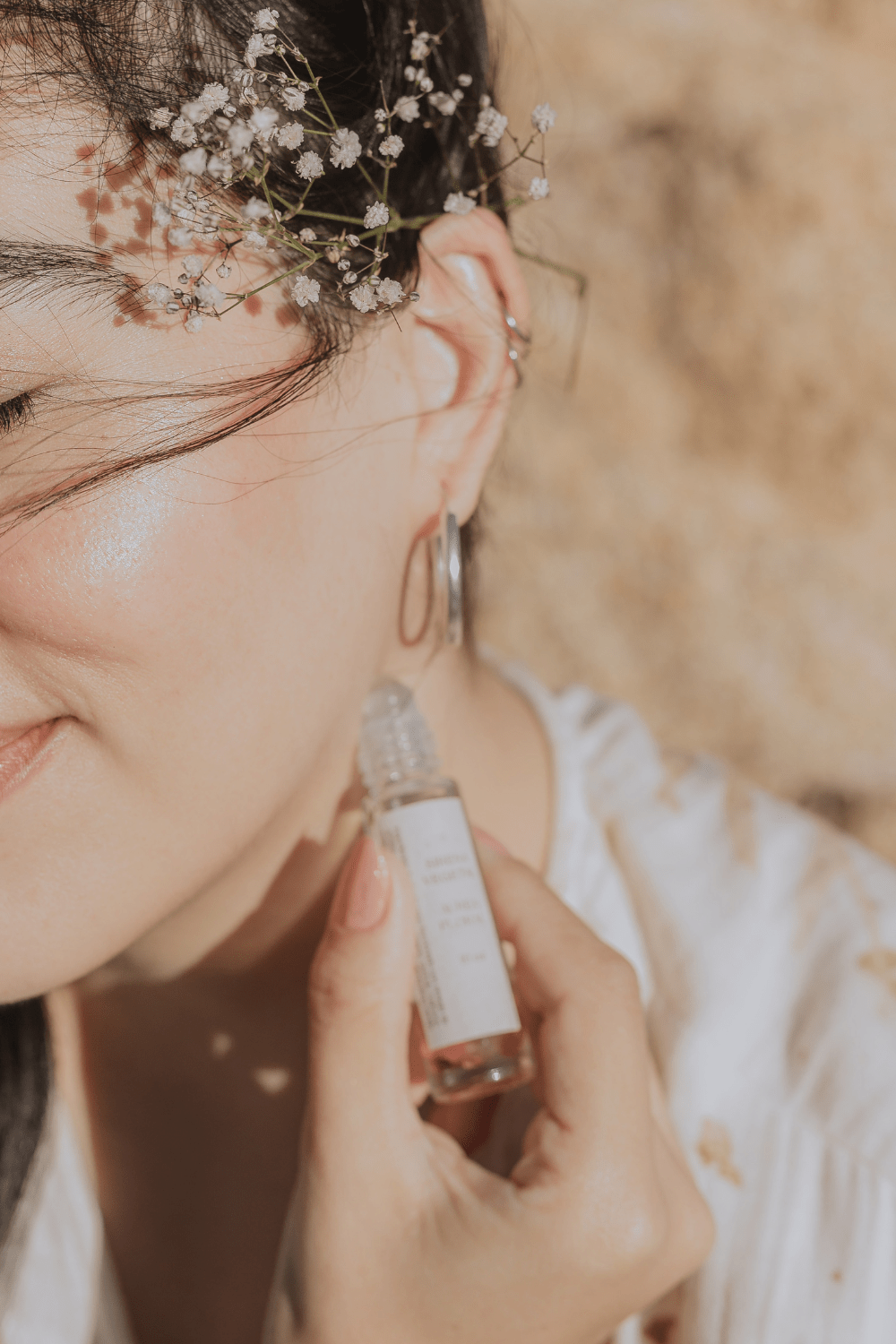 girl applying essential oils with a roller bottle